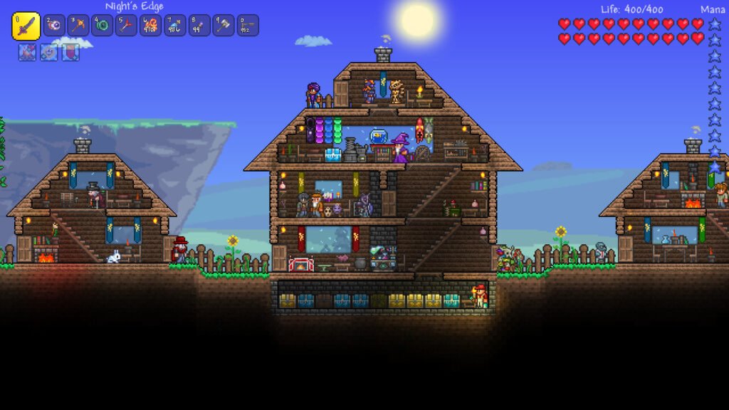 Base com casas de madeira cheias de NPCs, jogador com 400 de vida e a Night's Edge, pronto para o Hardmode no Terraria