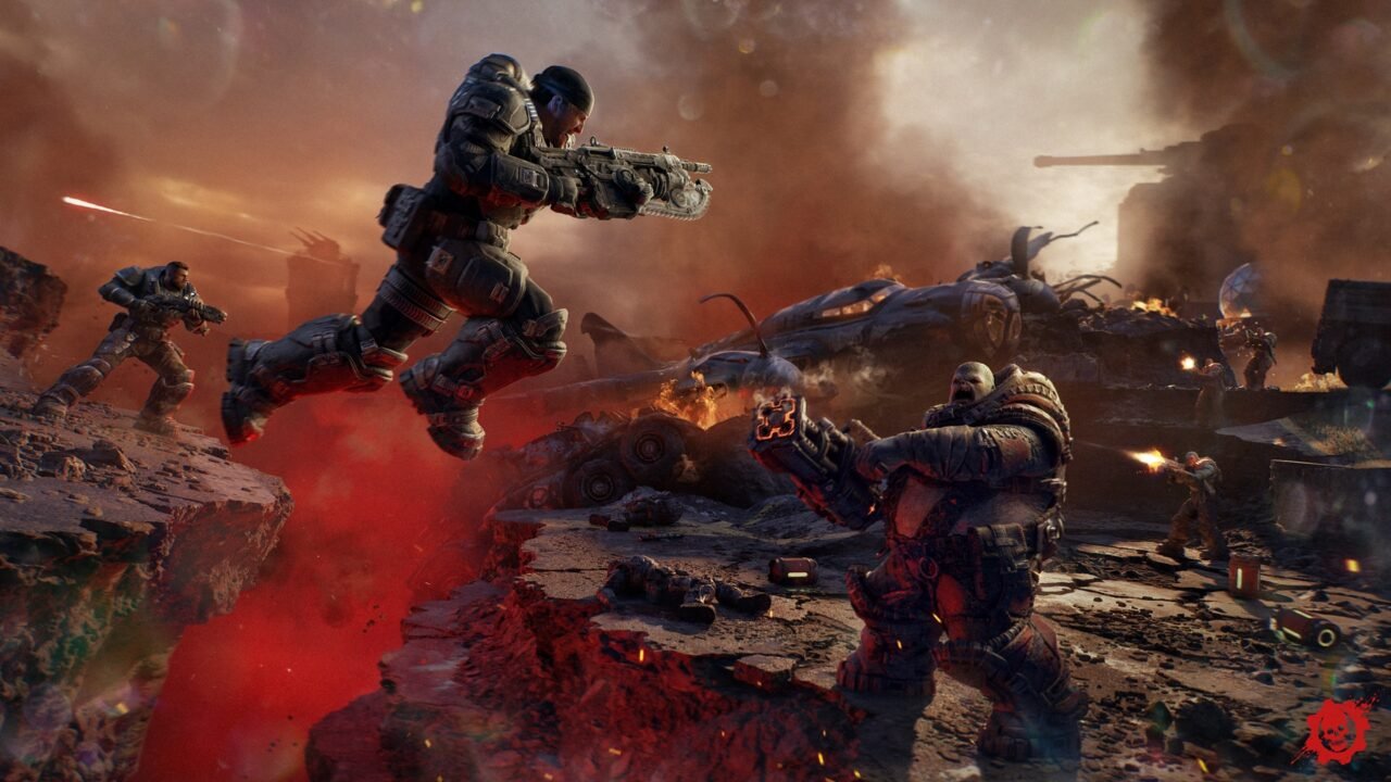 Soldados de armadura atiram e saltam sobre uma fenda vermelha num campo de batalha em Gears of War: E-Day