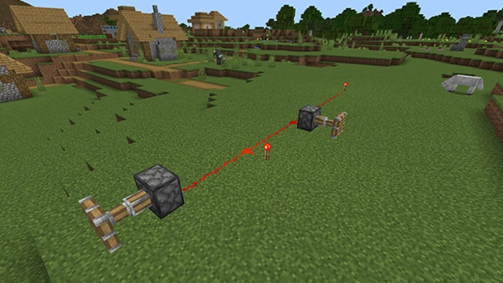 Dois pistões ligados por uma trilha de pó de redstone, com uma tocha de redstone no meio do caminho