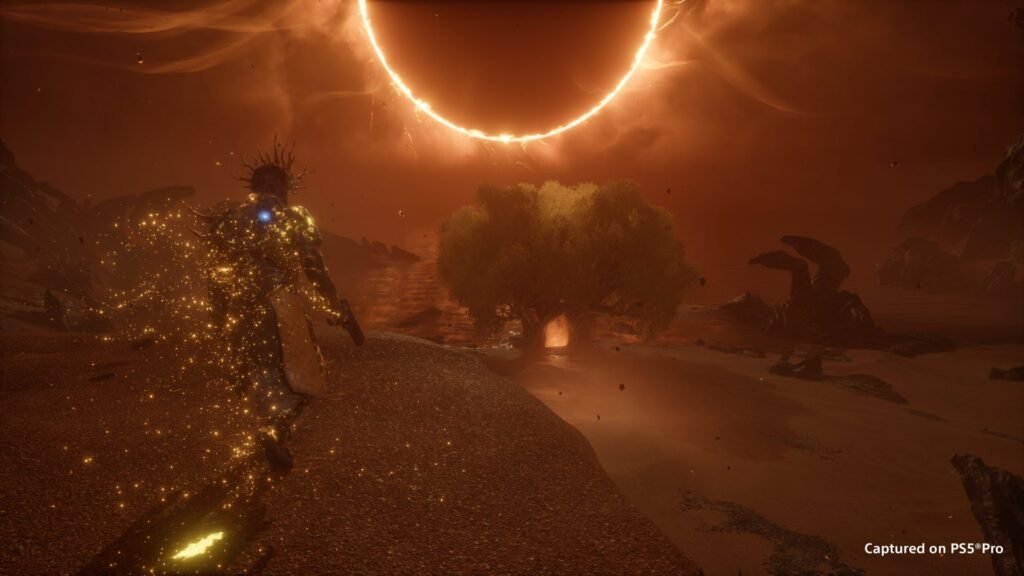 Arjun com a armadura brilhando em dourado caminha por um deserto vermelho sob um eclipse